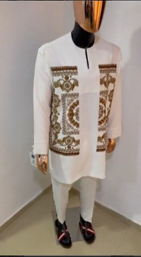 Ivory senator with gold and brown baroque print panels on the chest and hem, with white trousers