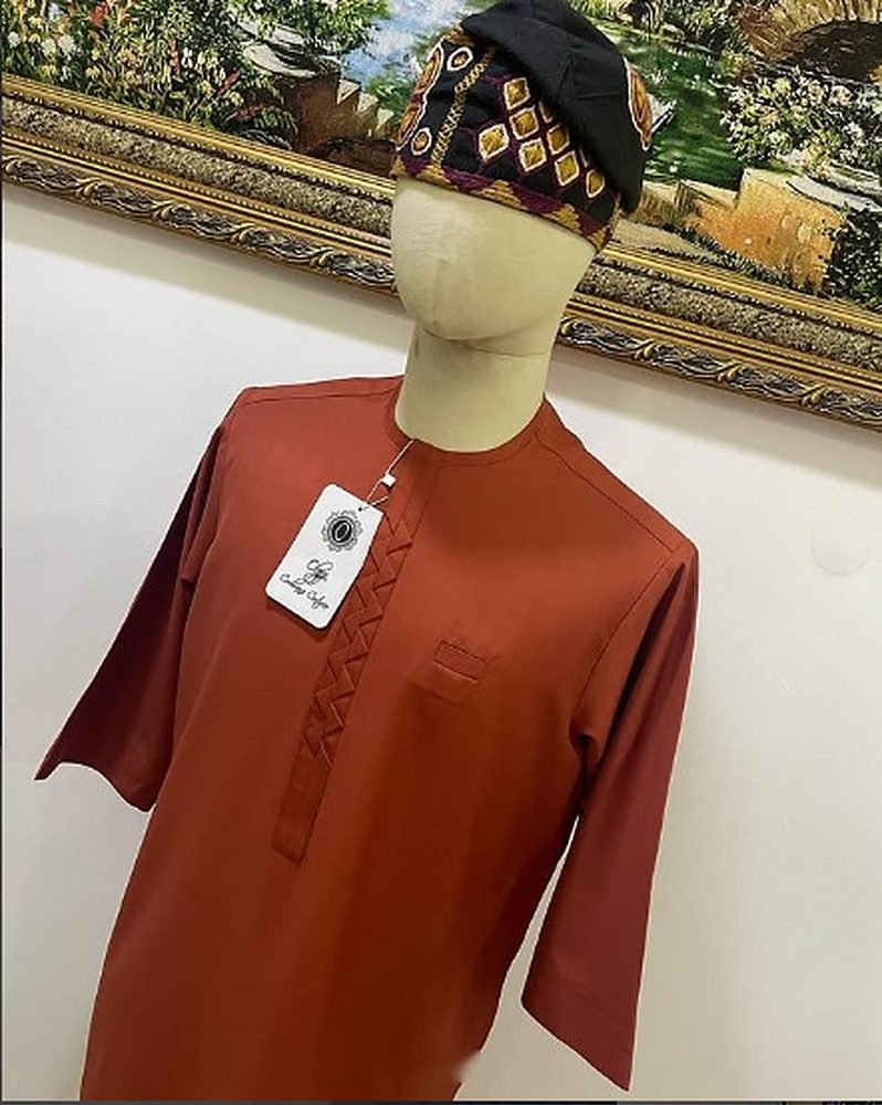 Terracotta senator shirt with hand-stitched zigzag placket and chest welt pocket on a mannequin